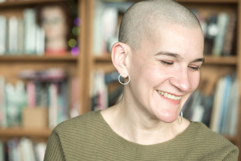 April’s Headshot Oct ’24 - A headshot of April caught mid-laugh.